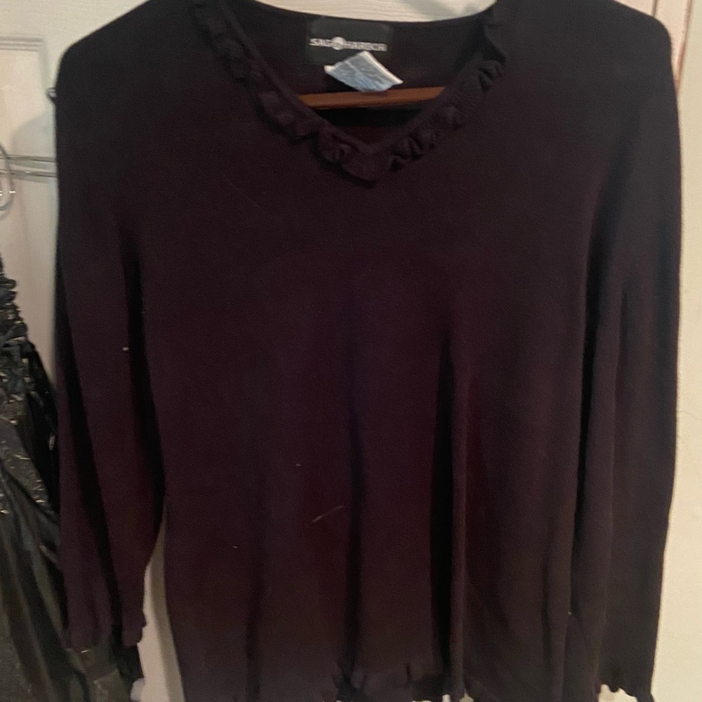 Black sweater with ruffles at the collar